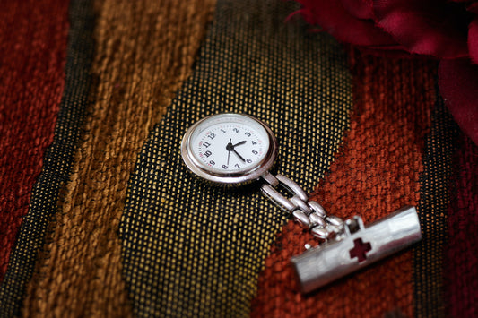 Bruchin Noeka silver pocket watch. Silver variant on a table cloth.