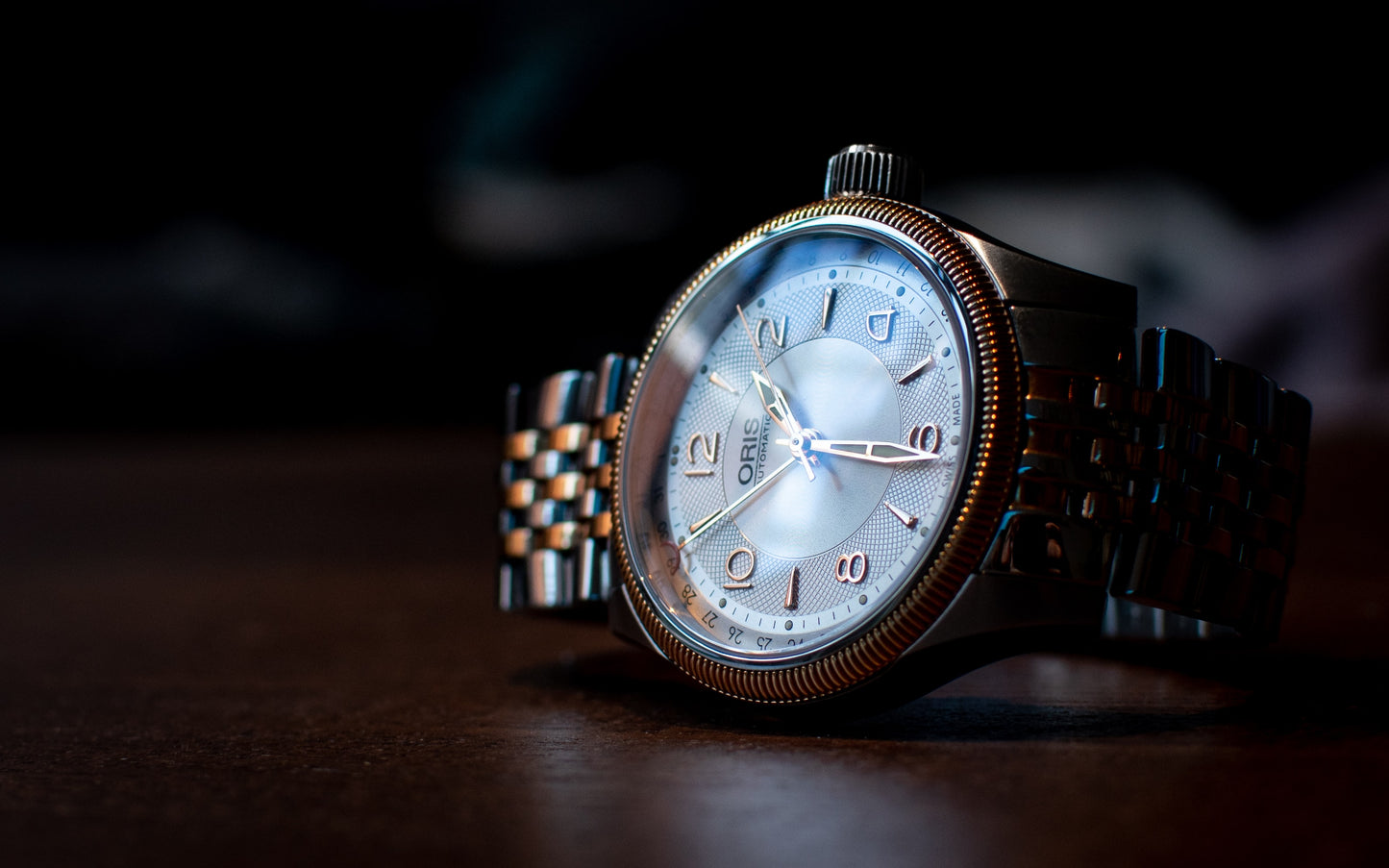 Joe Hepburn watch made by Oris. Silver and gold trim with a silver face.