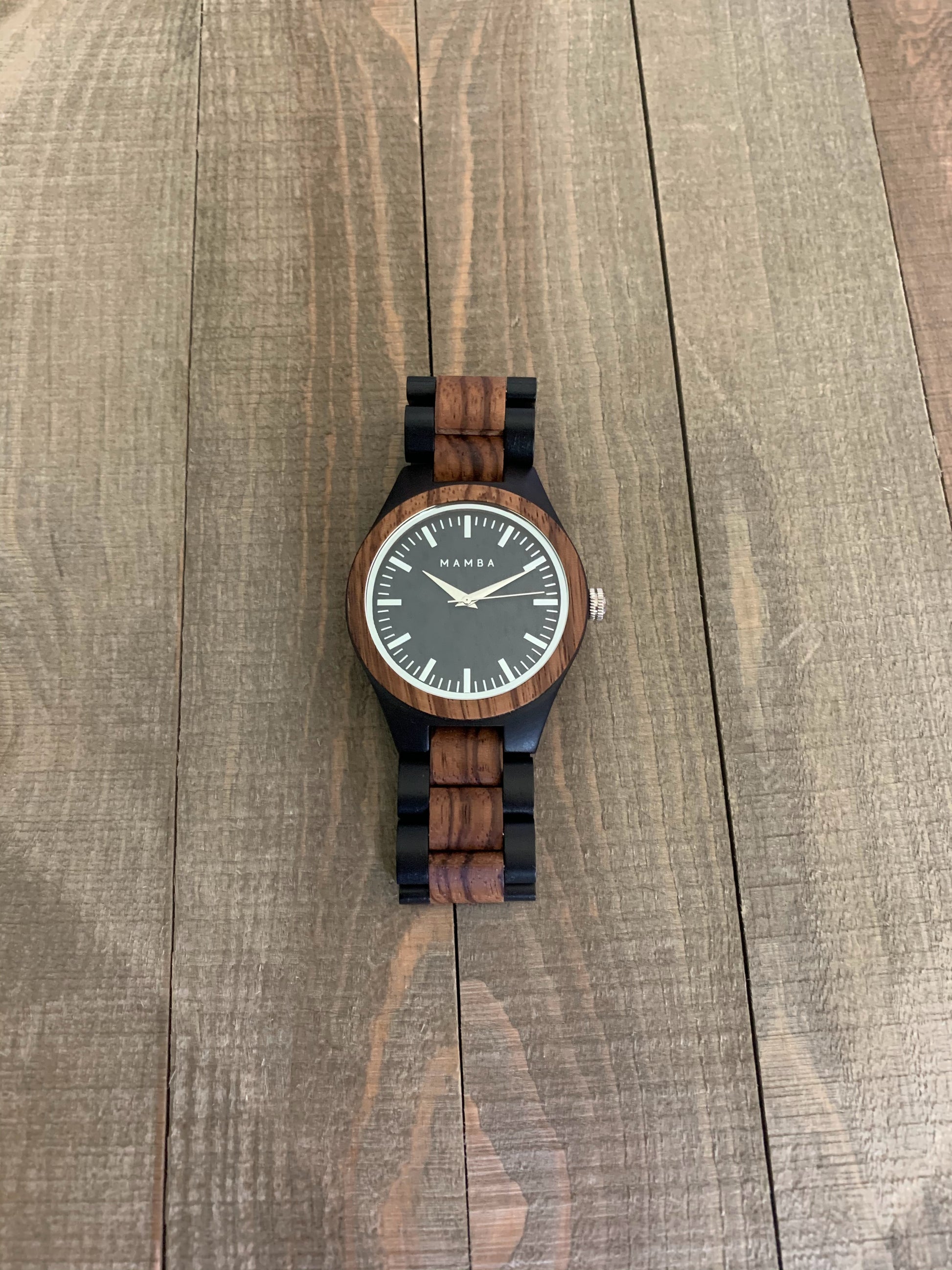 Mamba watch with unique wooden strap and face. Black trim with brown wood.